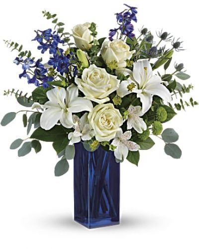 <p>With its deep cobalt glass vase and pure white blooms, this soothing bouquet is a stylish gesture for any special occasion!<br />
This arrangement includes white roses, white asiatic lilies, white alstroemeria, green button spray chrysanthemums, blue eryngium, bupleurum, spiral eucalyptus, silver dollar eucalyptus, and lemon leaf.</p>