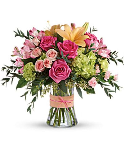 <div id="mark-3" class="m-pdp-tabs-marketing-description">Put a spring in their step with this beautifully blushing bouquet of hot pink roses, soft peach lilies and fresh green hydrangea. Arranged in a graceful vase tied with a charming bow, it's a chic treat for any occasion!</div>
<div id="desc-3">
<ul>
 	<li>This sweet arrangement features green hydrangea, hot pink roses, pink spray roses, peach asiatic lilies, pink alstroemeria, green carnations, pink miniature carnations, seeded eucalyptus, parvifolia eucalyptus, and lemon leaf.</li>
</ul>
</div>