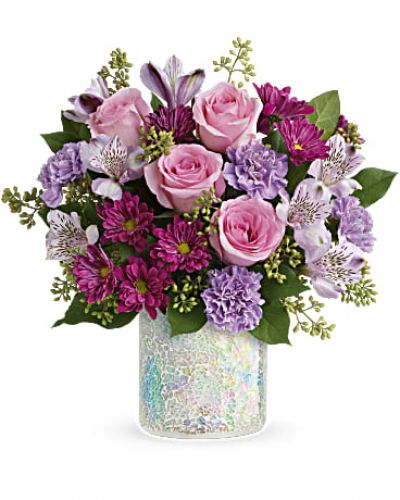 <p>Mother's Day is sure to shine when you surprise Mom with this luxurious gift of lavender and pink blooms arranged in a stunning iridescent mosaic glass vase.<br />
This gorgeous bouquet features pink roses, lavender alstroemeria, lavender carnations, purple daisy spray chrysanthemums, seeded eucalyptus, and lemon leaf.</p>