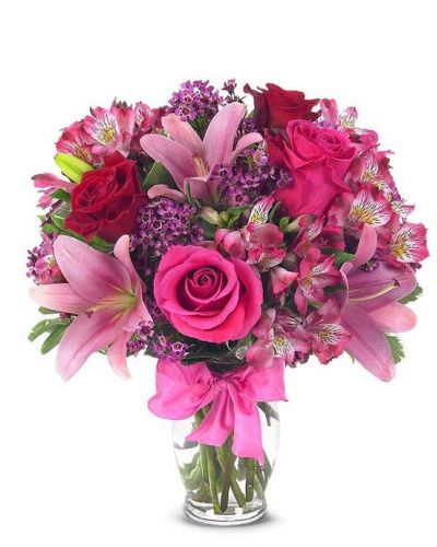 <p>This sweetly flirtatious combination of Asiatic lilies, waxflower, alstroemeria and roses makes a thoughtful gift they'll not soon forget. A pretty pink ribbon and clear fluted glass vase add to the romantic look.</p>
