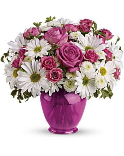 <p>Make their spirits soar with a surprise bouquet of pink roses and white daisies in a dazzling fuchsia ginger jar. This classic vase, is not only beautiful, but beautifully affordable. They'll love it for years.<br />
The lush bouquet includes pink roses, pink spray roses, white daisy spray chrysanthemums and white button spray chrysanthemums accented with fresh greenery.</p>