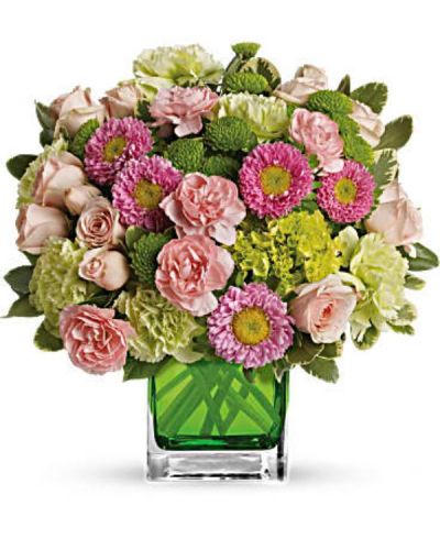 <p>This sweet bouquet includes a vast array of green miniature hydrangea and light pink spray roses arranged in our citrus green glass cube.<br />
Includes green miniature hydrangea, light pink spray roses, green carnations, pink miniature carnations, pink matsumoto asters and green button spray chrysanthemums accented with assorted greens</p>
