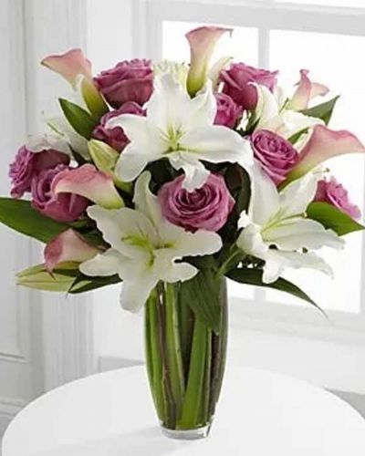 <p>Flowing with unparalleled elegance, this fresh from the farm bouquet offers blooming beauty in soft shades of pink, lavender and white. Brilliant white Oriental Lilies stretch their long star-shaped petals across a bed of pink miniature calla lilies and 20-inch lavender roses all accented with vibrant, lush greens. Seated in a superior clear glass vase, this bouquet is a wonderful way to commemorate a special moment.</p>