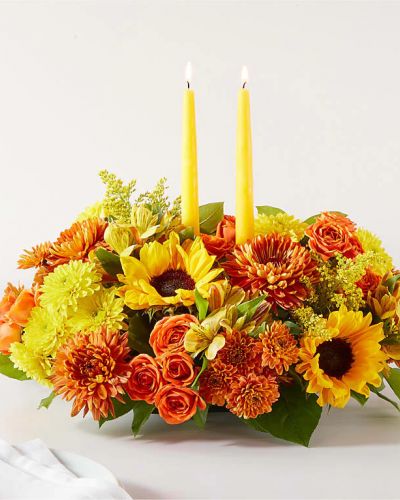 <p>Enjoy a candlelit dinner with this colorful arrangement that embraces every shade of fall.</p>