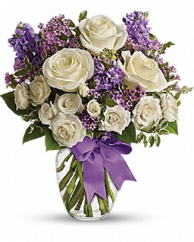 <div class="m-pdp-tabs-description">
<div id="mark-1" class="m-pdp-tabs-marketing-description">This magical bouquet will be at home in a cottage, a condo, a studio or an estate. It's so pretty it will be appreciated by all those lucky enough to receive it. Enchant someone today!</div>
</div>
<p id="arrngDescp">White roses and spray roses, lavender stock and waxflower, all perfectly arranged in a clear glass vase that's wrapped with purple ribbon.</p>